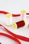 Coils with multicolored white, red, pink threads and red decorative ribbon
