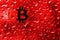 Coin bitcoin behind glass with red drops.