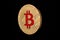 Coin bitcoin made of gold, isolated on a black background