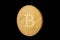 Coin bitcoin made of gold, isolated on a black background