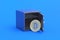 Coin of cryptocurrency bitcoin near strongbox on blue background