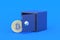 Coin of cryptocurrency bitcoin near strongbox on blue background