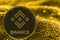 Coin cryptocurrency BNB on golden background. Binance.