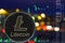 Coin cryptocurrency litecoin on night city background and chart.