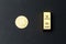 A coin of gold bitcoin next to a gold bar. Bitcoin Conservation. Cryptocurrency. Close-up. Virtual money. Copy space