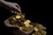 Coin gold in lady hand on lots stacking golden coins in broken jar white background, Money stack for business planning investment