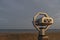 Coin operated binoculars overseeing the sea