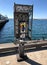 Coin operated Phone booth w graffiti by the ocean