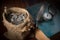 Coin in sack with feather, pocket watch and book.