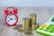 Coin stack Calculator and red alarm clock Blur Time concept Business investment Economic income Security Financial risk Real