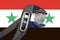 The coin in vise on the background of flag of Syria