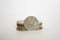 Coin worth two rupees. a coin on a white background stands vertically in a row with other coins piled in a stack