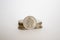 Coin worth two rupees. a coin on a white background stands vertically in a row with other coins piled in a stack