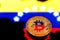 coins Bitcoin, amid Colombia flag, concept of virtual money, close-up. Conceptual image.