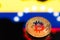 Coins Bitcoin, amid Colombia flag, concept of virtual money, close-up. Conceptual image.