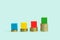 Coins and colored wooden blocks like bars infographic