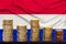 Coins of the European Union currency against the background of the flag of the Netherlands country, financial concept, dynamics of