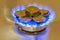 Coins of on the gas burner of the kitchen stove