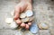 Coins on hand, child playing and holding Indian currency coins on wooden background, collect penny, pennies