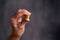 Coins held by fingers. Gold coins in a hand close-up