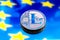 Coins litecoin, against the background of Europe and the European flag, the concept of virtual money, close-up. Conceptual image.