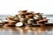 Coins pile, white background, selective focus emphasizes savings concept