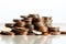 Coins pile, white background, selective focus emphasizes savings concept