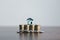Coins stack with mini house on wooden table, home loan, Save money concept, Property investment, house loan, reverse mortgage,