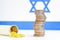 Coins stacked on each other in different positions on colored background. Israeli economy. Pharmaceutical industry in Israel
