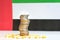 Coins stacked on each other in different positions on colored background. United Arab Emirates economy. Pharmaceutical industry in
