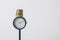 Coins stand on a black clock on a white background, a stack of coins as a symbol of payment for working time