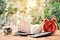 Coins and wood house with red alarm clock office equipment on table tree bokeh background