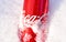 Coka-Cola Can at snow and ice background in winter. Cola is a sweet carbonated soft drink. Iced aluminum cans by Coke. Sparkling