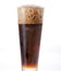 Coke in a glass. Carbonated cold drinks foaming on top after being poured into clear glass