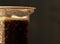 Cola drink with fizz in a plastic glass. Closeup, night