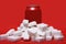 Cola refreshing drink can and lot of white sugar cubes representing the big amount of calories