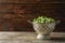 Colander with Brussels sprouts on wooden background.