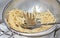 Colander with leftover spaghetti pasta, close-up on a white background