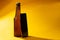 cold beer closed on a yellow background with cell phone shadows