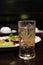 Cold Beer in glass and ice and food on table, Beer is Beverage Alcohol in foods shop night time selective focus