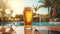 cold beer by the pool, its crispness beautifully captured in a transparent glass against picturesque sky and sun.