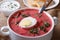 Cold beet soup with egg and herbs closeup. horizontal