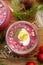 Cold beetroot soup, cold served with the addition of cucumbers, radishes, boiled eggs and fresh herbs, dill, green onions in glass