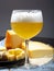 Cold belgian beer in glass served in cafe with variety of hard cheeses, tasty european food