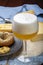 Cold belgian beer in glass served in cafe with variety of hard cheeses, tasty european food
