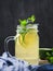 Cold beverage mojito in a glass jar with lime and mint