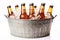 Cold bottles of beer with condensation droplets in the metal bucket with ice isolated on white background