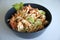 Cold chicken pasta salad in a grey bowl