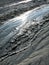 Cold clayey mud mixed with hydrocarbons, flows down from a mud volcano in the natural reserve of Salse of Nirano.