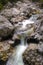 Cold clean water flows over the rocks in the mountains